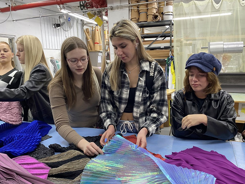 Fashion students looking at fabrics
