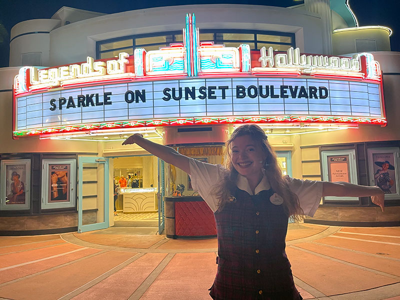 Young woman in front of movie theater at Disney World