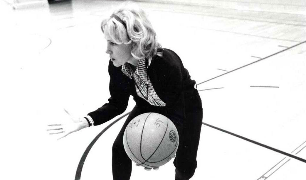 Woman basketball coach on court