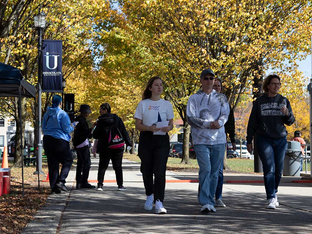 Student and parents walking on college campus