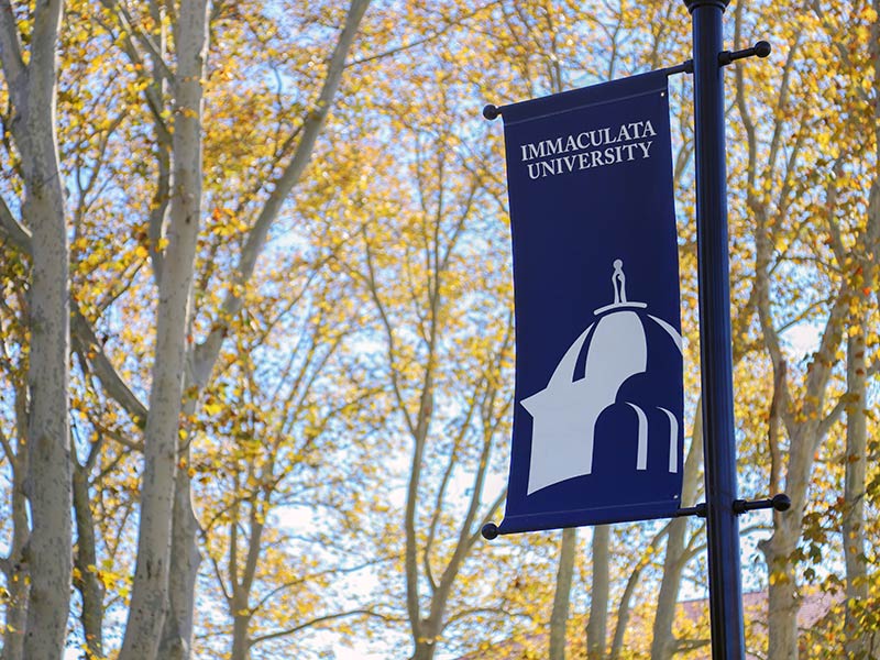 Lightpost with banner reading "Immaculata University"