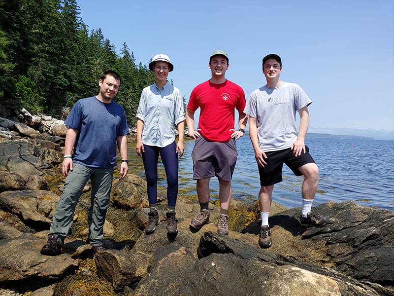 Students and professor outdoors in Maine