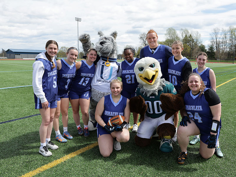 Flag football players with Eagles mascot Swoop.