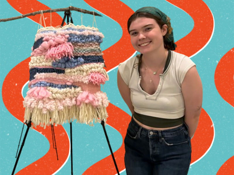 Student displaying fabric art