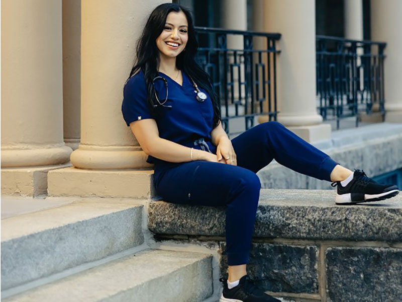 lara-escarlet Woman in nursing scrubs sitting on steps