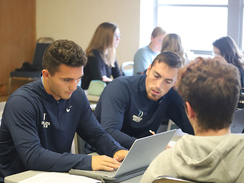 College students working together in classroom