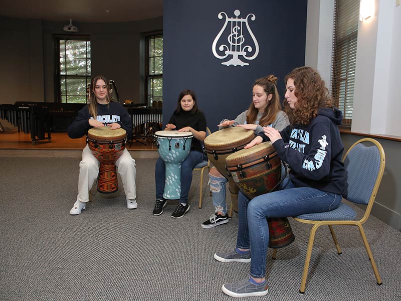 Four women playing drums