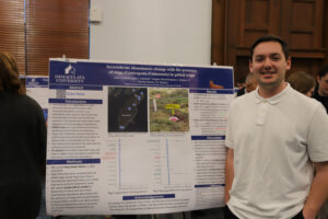 College student in front of research poster