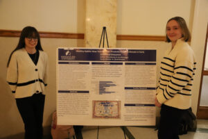 Two women in front of research poster