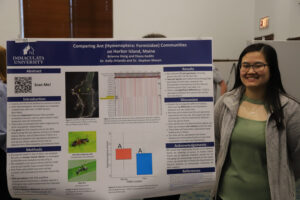 College student in front of research poster