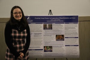 College student in front of research poster
