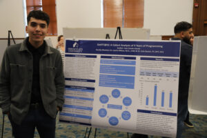 College student in front of research poster