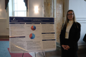 College student in front of research poster