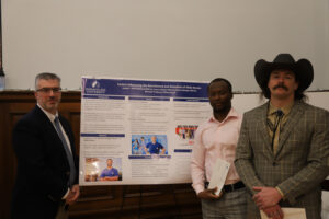 Three people in front of research poster
