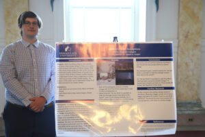 College student in front of research poster