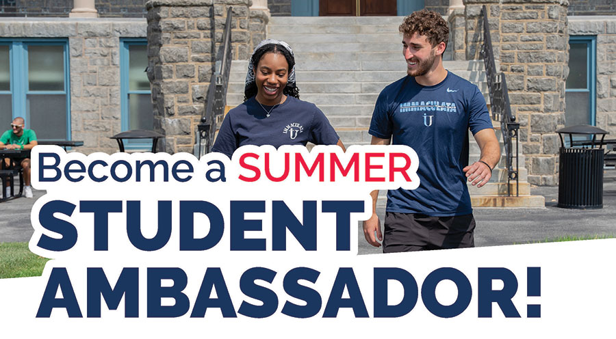 Two students in front of a college building.