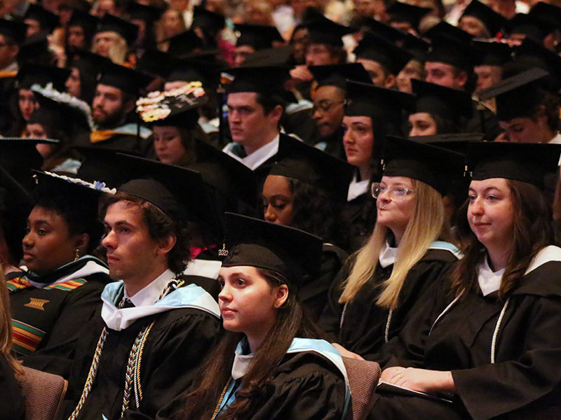 College students in caps and gowns at commencement ceremony