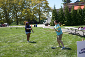 Two students playing stickball