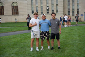 Three young men smiling for the camera