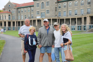 Five people standing in front of a college building