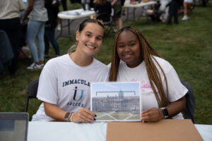 Two college students at a table promoting Student Government Association