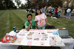 Two college students behind a table promoting Psychology Club