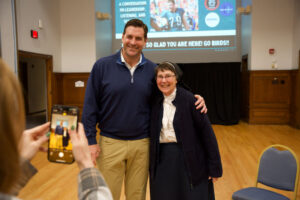 Large man with arm around nun