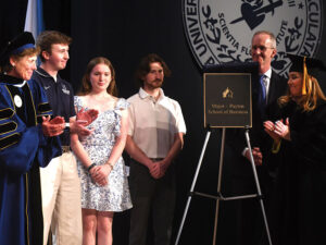 A group of people on stage at commencement ceremony