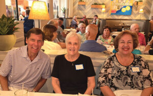 A man and two women at event