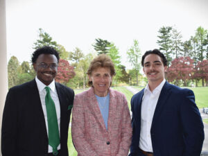 A woman standing between two men