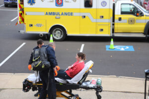 Man on stretcher in front of ambulance