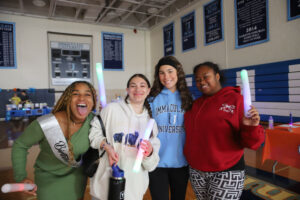Four young women smiling and laughing.