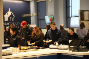People getting food in a college dining hall