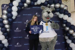 Young woman with college mascot