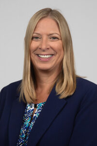 Everett_Renee - Immaculata University Professional headshot of a smiling woman with shoulder-length blonde hair wearing a navy blazer.