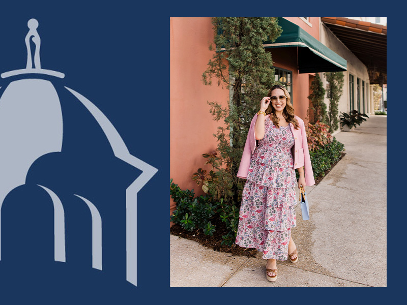 An image on a dark blue background with a light blue graphic of a multi-tiered dome on the left, next to a photo of a woman in a long, pink, flamingo and floral print tiered dress. She has a pink jacket draped over her shoulders, and is holding on to the top of her sunglasses with her right hand, smiling. She is walking on a paved pathway next to a building, with small trees and other plants in front. The building has a large, green awning.
