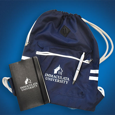 sack - Immaculata University Navy Immaculata University drawstring backpack with white logo, paired with a black notebook and pen on a blue background.