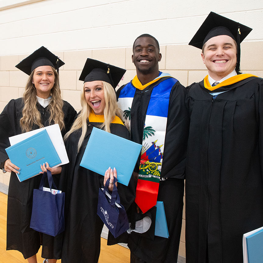 Affordable Immaculata University Degrees - four students smiling after graduation