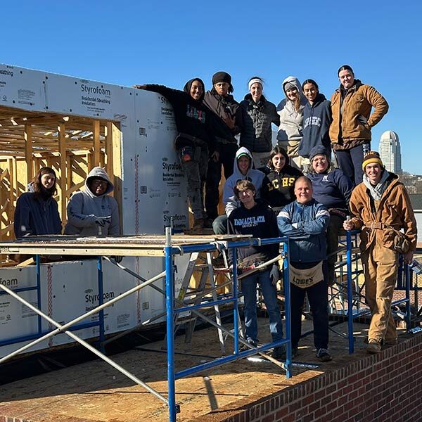 Group of young people building a house