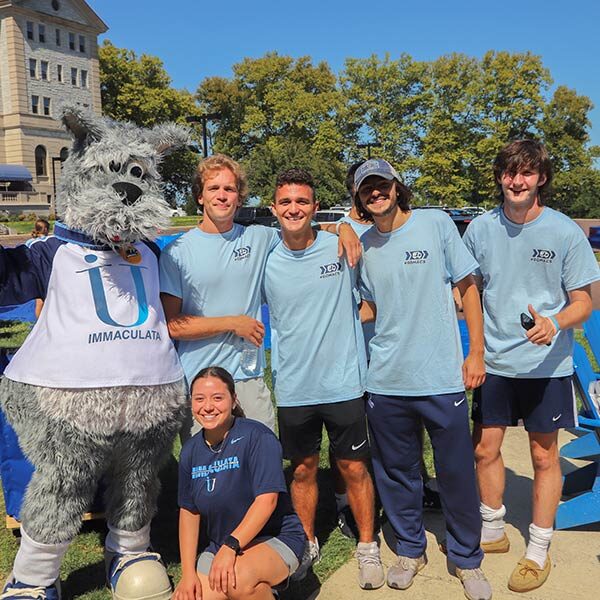 Group of college students with mascot in costume